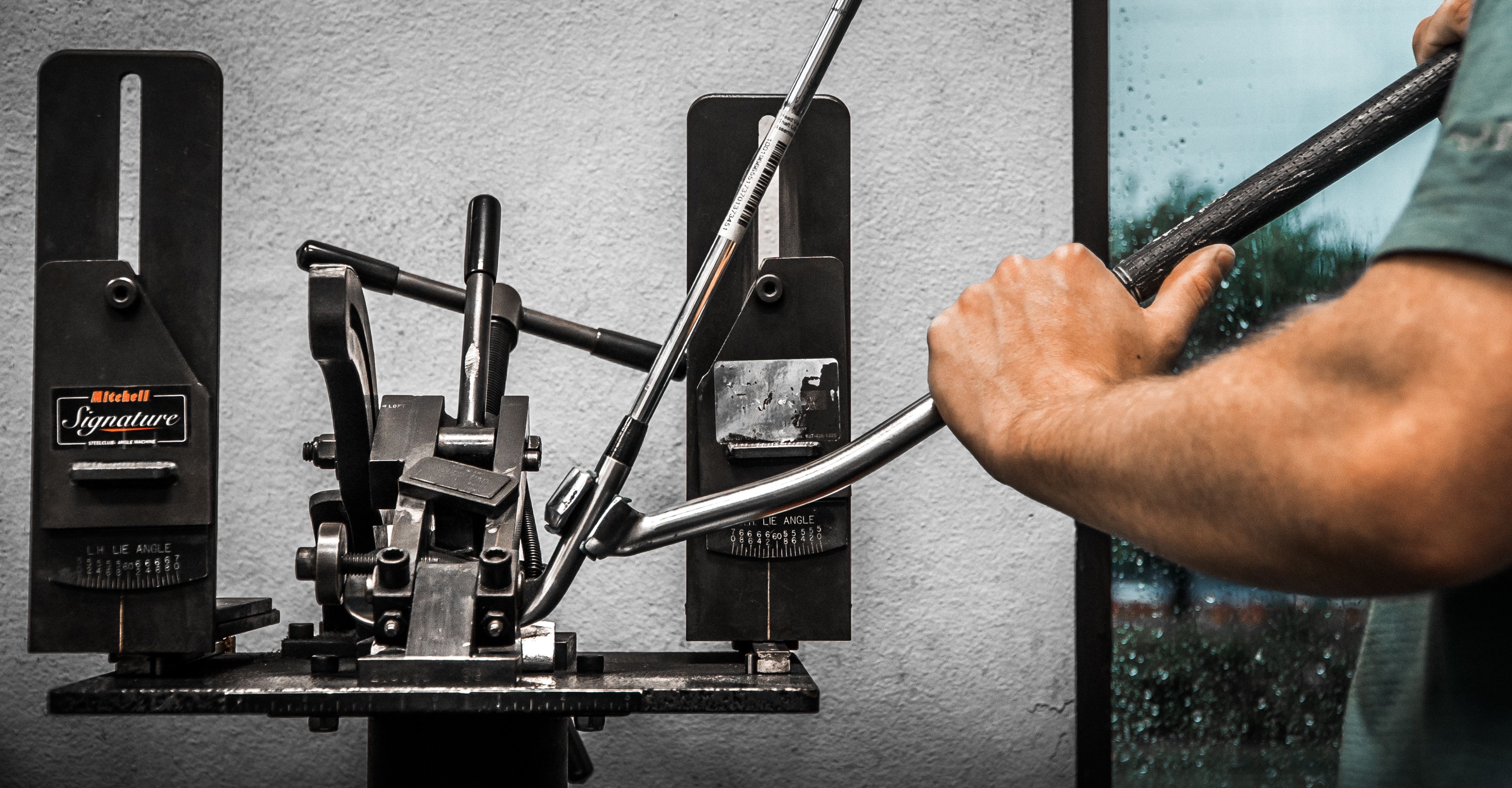 Bending a club on the Mitchell machine at The Golf Station