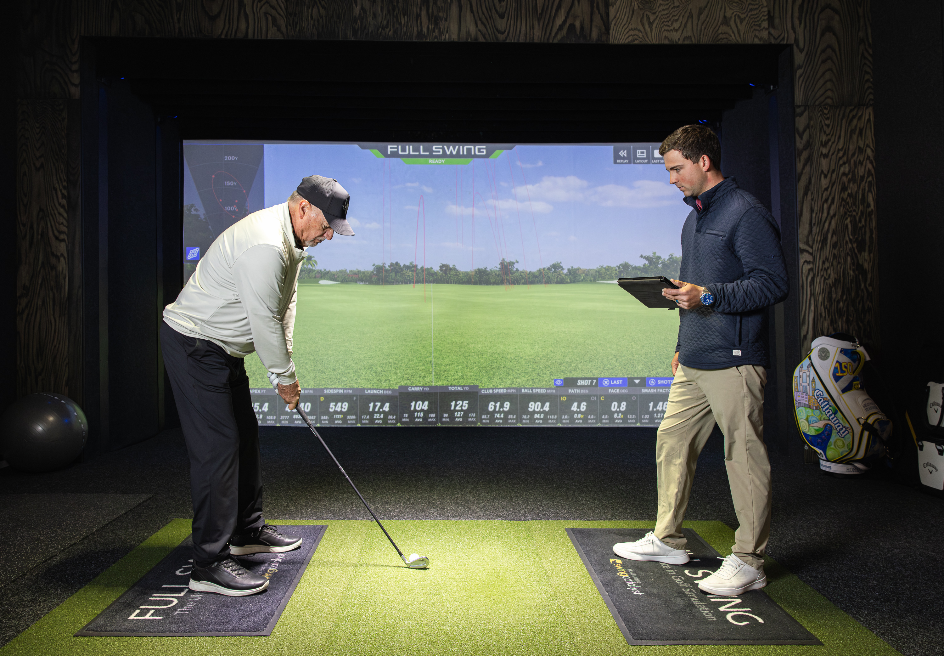 Fitter reviewing launch monitor data with a golfer at The Golf Station